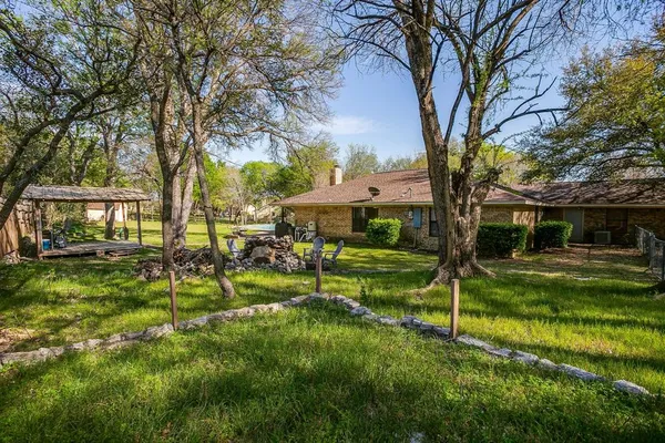 a swimming pool with outdoor seating and yard