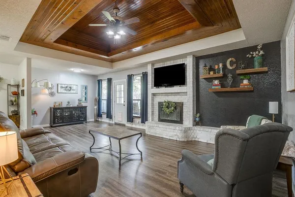 a living room with furniture a fireplace and a flat screen tv