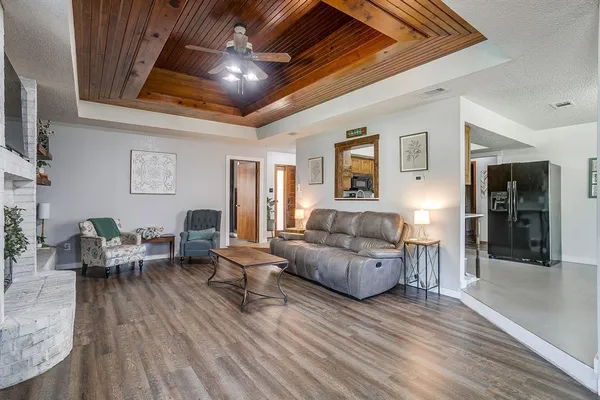 a living room with furniture and a wooden floor