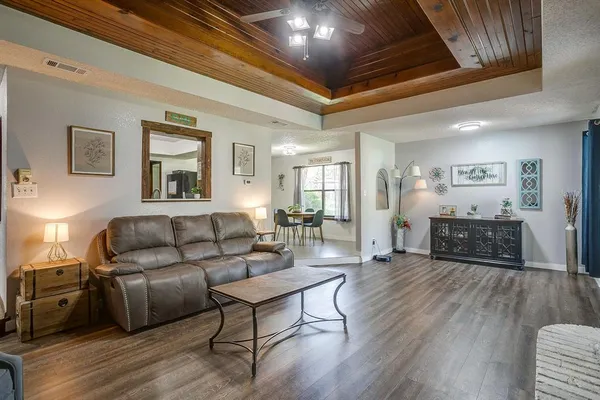 a living room with furniture and a wooden floor