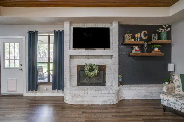 a living room with fireplace furniture and a flat screen tv