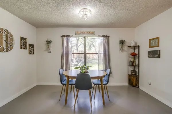 a view of a dining room with furniture and a window