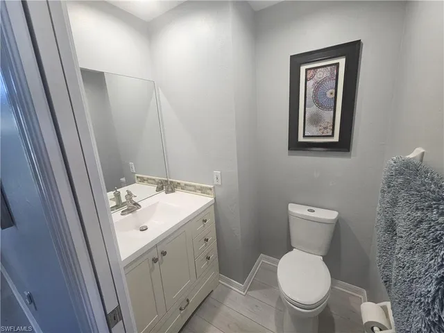 a bathroom with a sink a toilet and mirror