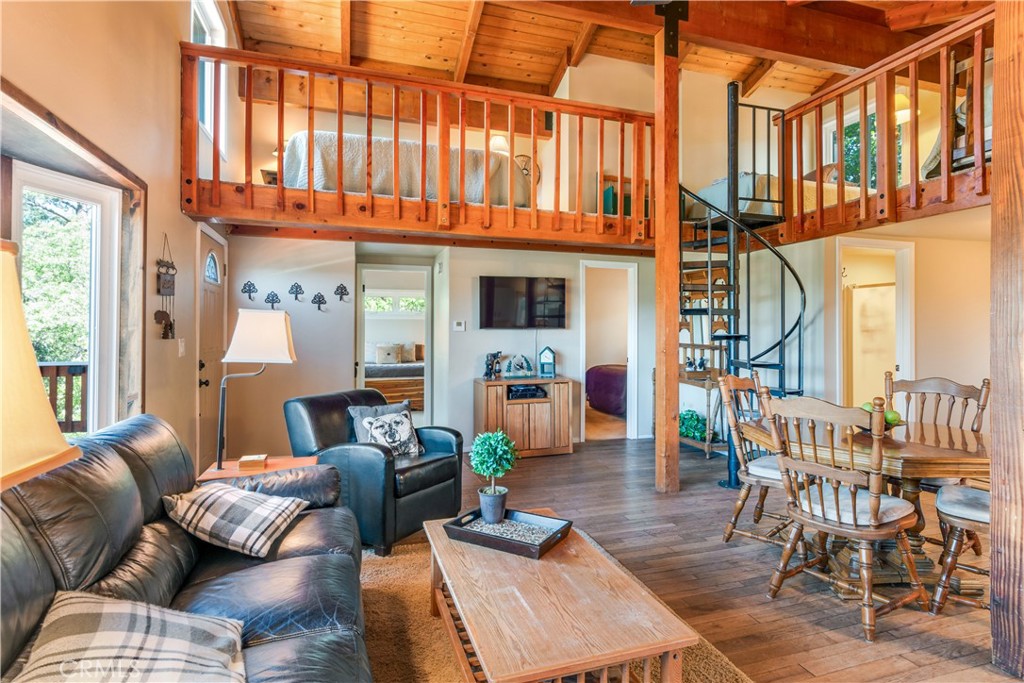 39576 Oakglen Road Fawnskin, CA 92333 - Photo 12 of 30 a living room with furniture a fireplace and a large window