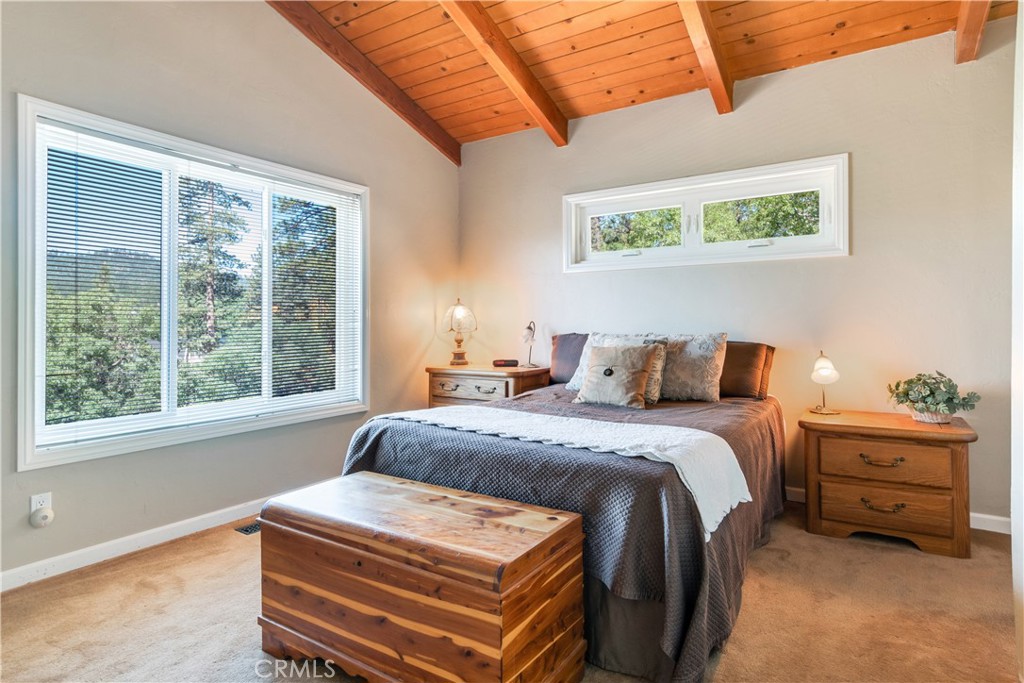 39576 Oakglen Road Fawnskin, CA 92333 - Photo 15 of 30 a bedroom with a bed and a window