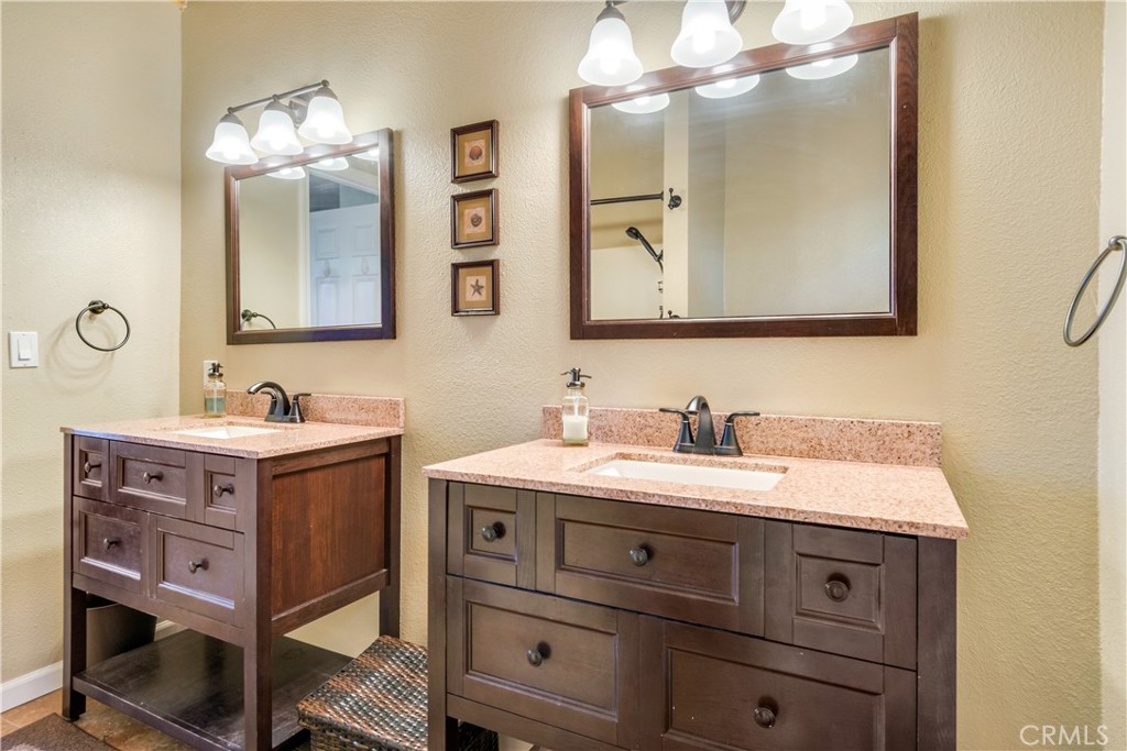 39576 Oakglen Road Fawnskin, CA 92333 - Photo 17 of 30 a bathroom with a sink vanity and a mirror