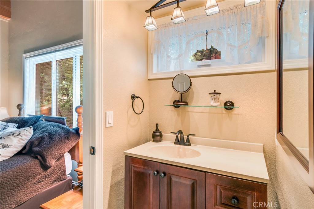 39576 Oakglen Road Fawnskin, CA 92333 - Photo 21 of 30 a bathroom with a sink and a mirror