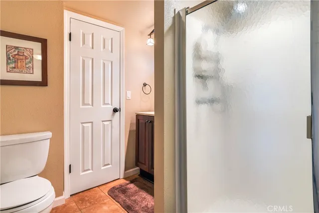 a bathroom with a toilet a sink and a shower