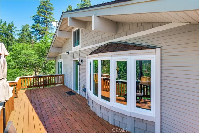 a view of a house with deck and wooden floor