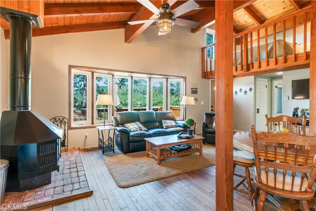 a living room with furniture a rug and a chandelier