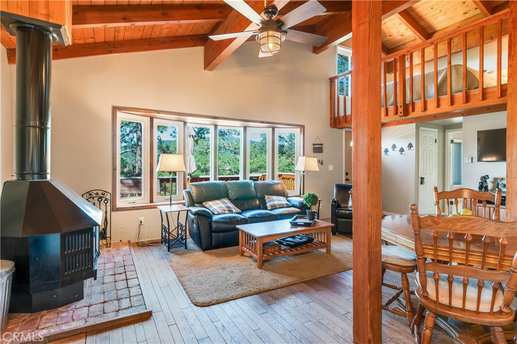 39576 Oakglen Road Fawnskin, CA 92333 - Photo 9 of 30 a living room with furniture a rug and a chandelier