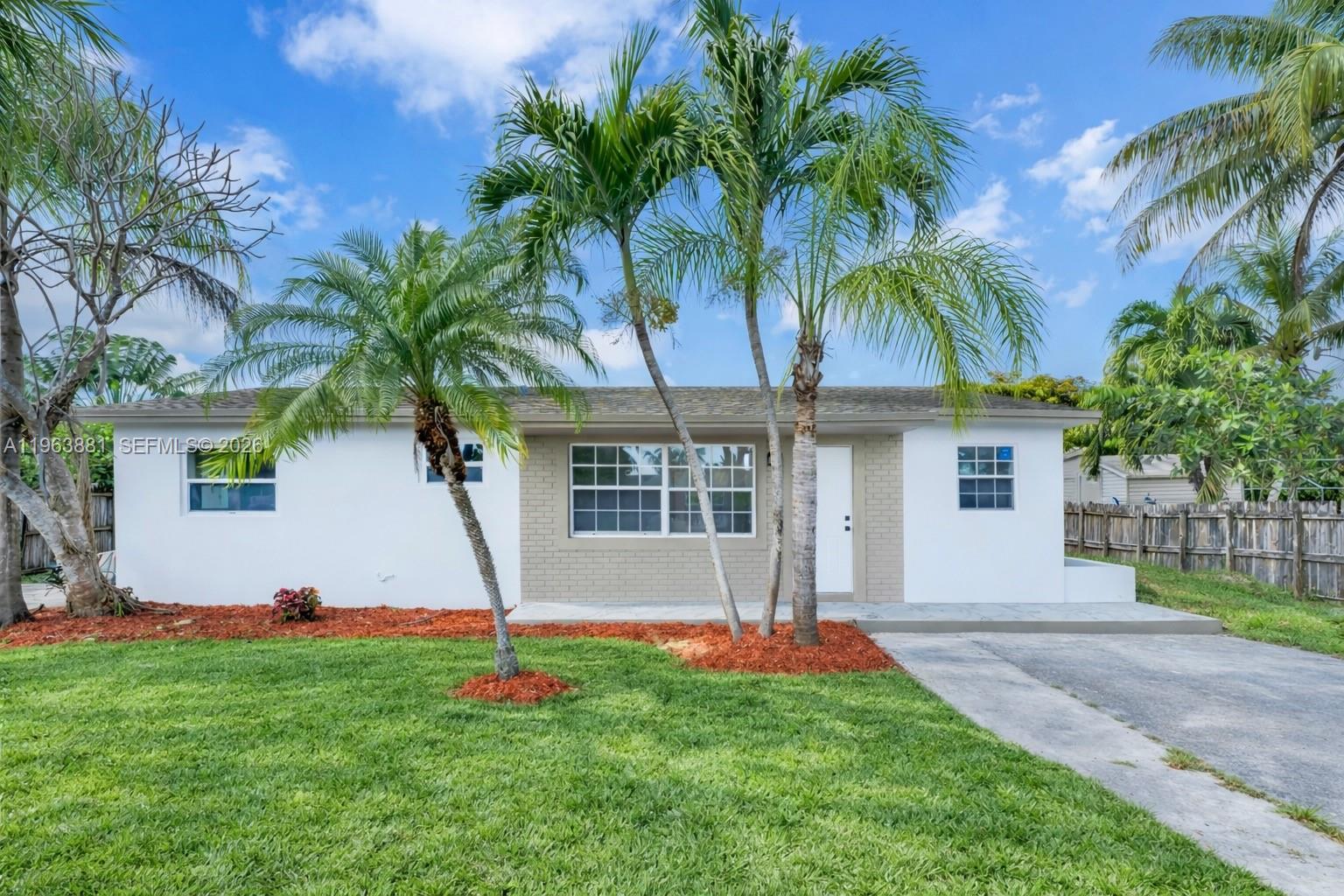 29822 Southwest 149th Avenue Homestead, FL 33033 - Photo 1 of 17 a front view of house with yard and green space
