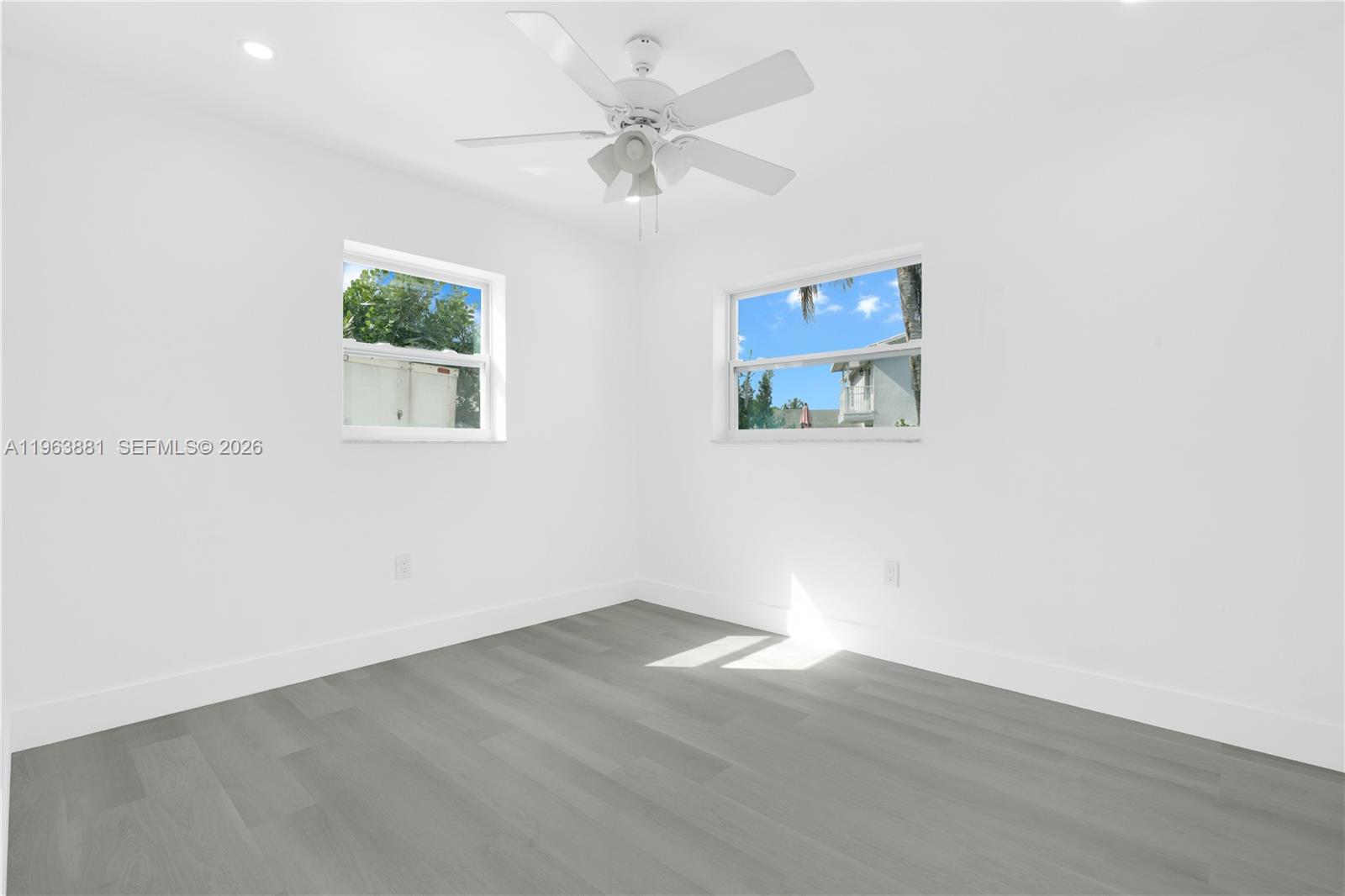 29822 Southwest 149th Avenue Homestead, FL 33033 - Photo 11 of 17 an empty room with a window and a fan