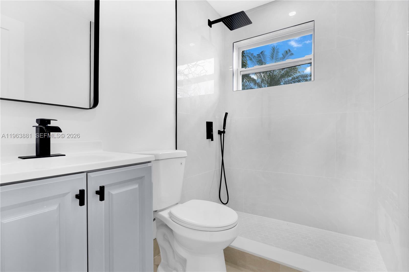 29822 Southwest 149th Avenue Homestead, FL 33033 - Photo 12 of 17 a bathroom with a sink a toilet and a mirror
