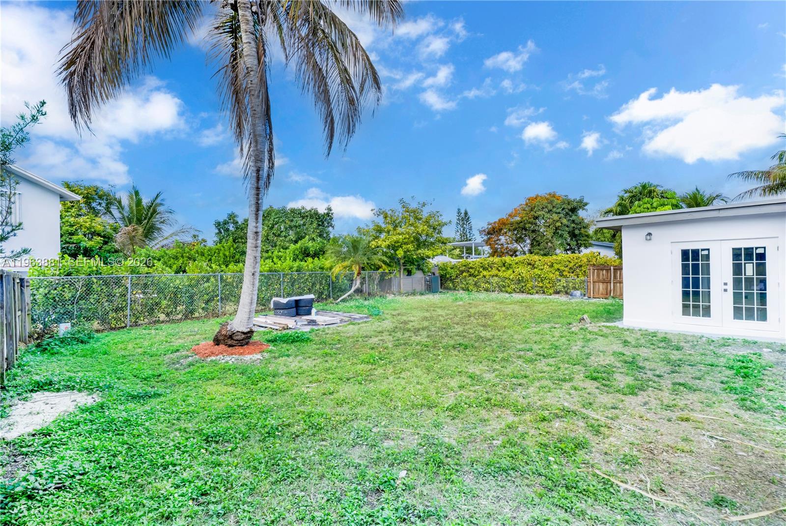 29822 Southwest 149th Avenue Homestead, FL 33033 - Photo 15 of 17 a view of a backyard with plants and a patio