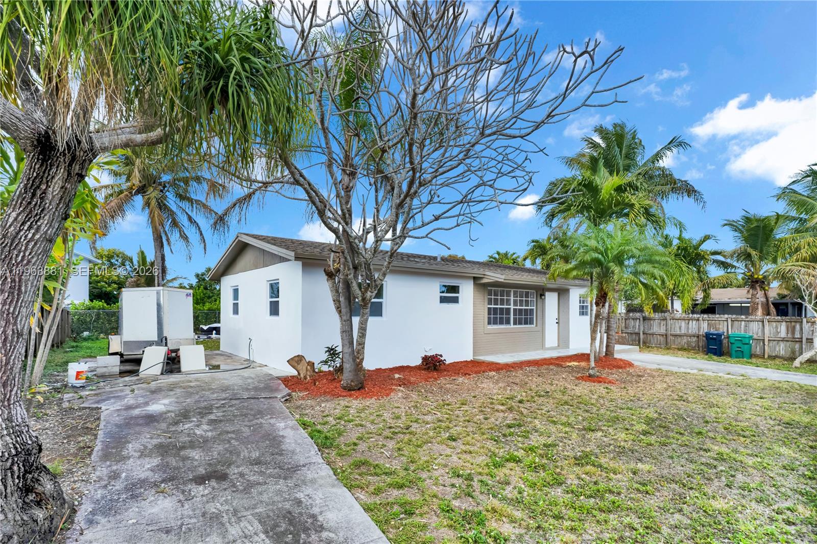 29822 Southwest 149th Avenue Homestead, FL 33033 - Photo 3 of 17 a view of a house with a tree in the yard