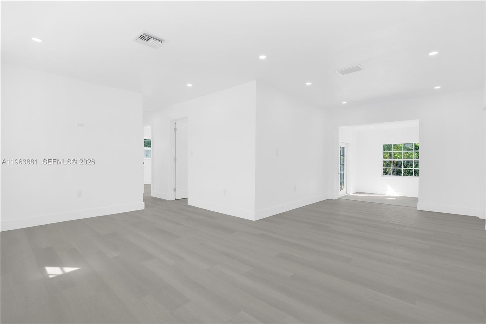 29822 Southwest 149th Avenue Homestead, FL 33033 - Photo 5 of 17 a view of an empty room with wooden floor