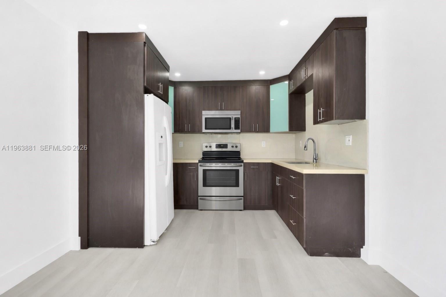 29822 Southwest 149th Avenue Homestead, FL 33033 - Photo 7 of 17 a kitchen with stainless steel appliances granite countertop a refrigerator and a stove