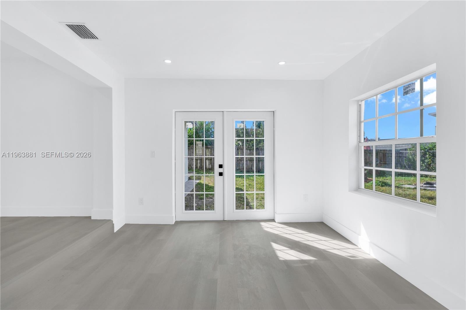 29822 Southwest 149th Avenue Homestead, FL 33033 - Photo 8 of 17 an empty room with windows