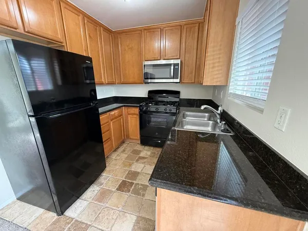 a kitchen with a sink stove and microwave