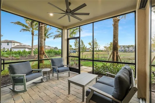 a living room with furniture and a floor to ceiling window