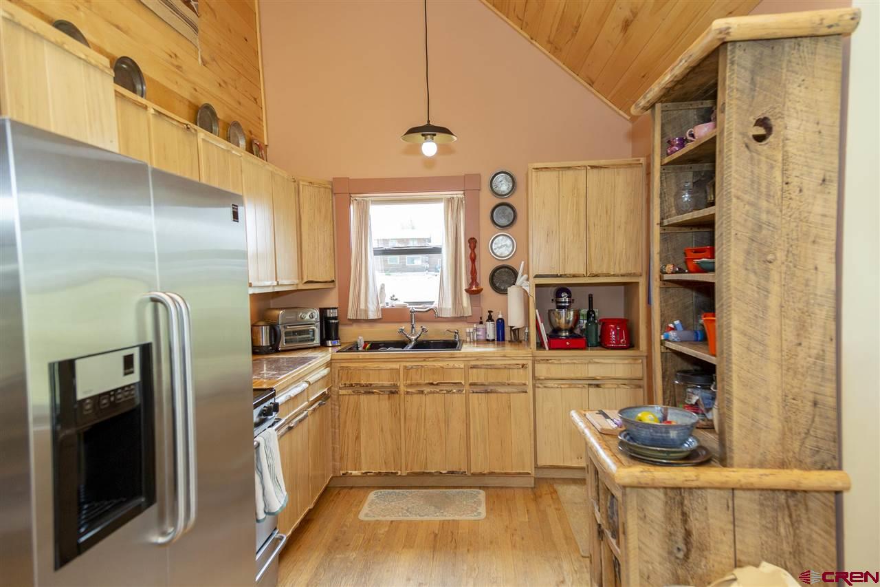 148 Rio Grande Drive Creede, CO 81130 - Photo 14 of 27 a kitchen with refrigerator and window