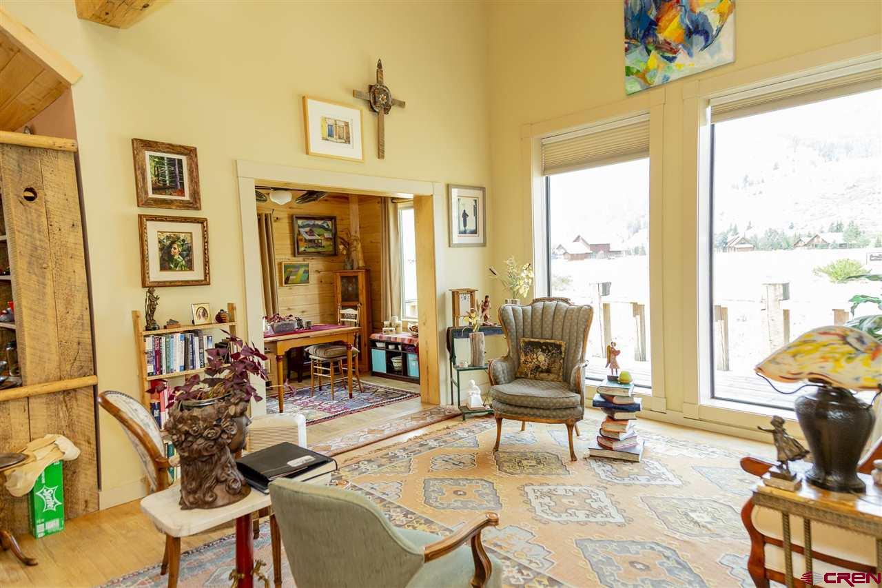 148 Rio Grande Drive Creede, CO 81130 - Photo 15 of 27 a living room with furniture and floor to ceiling windows