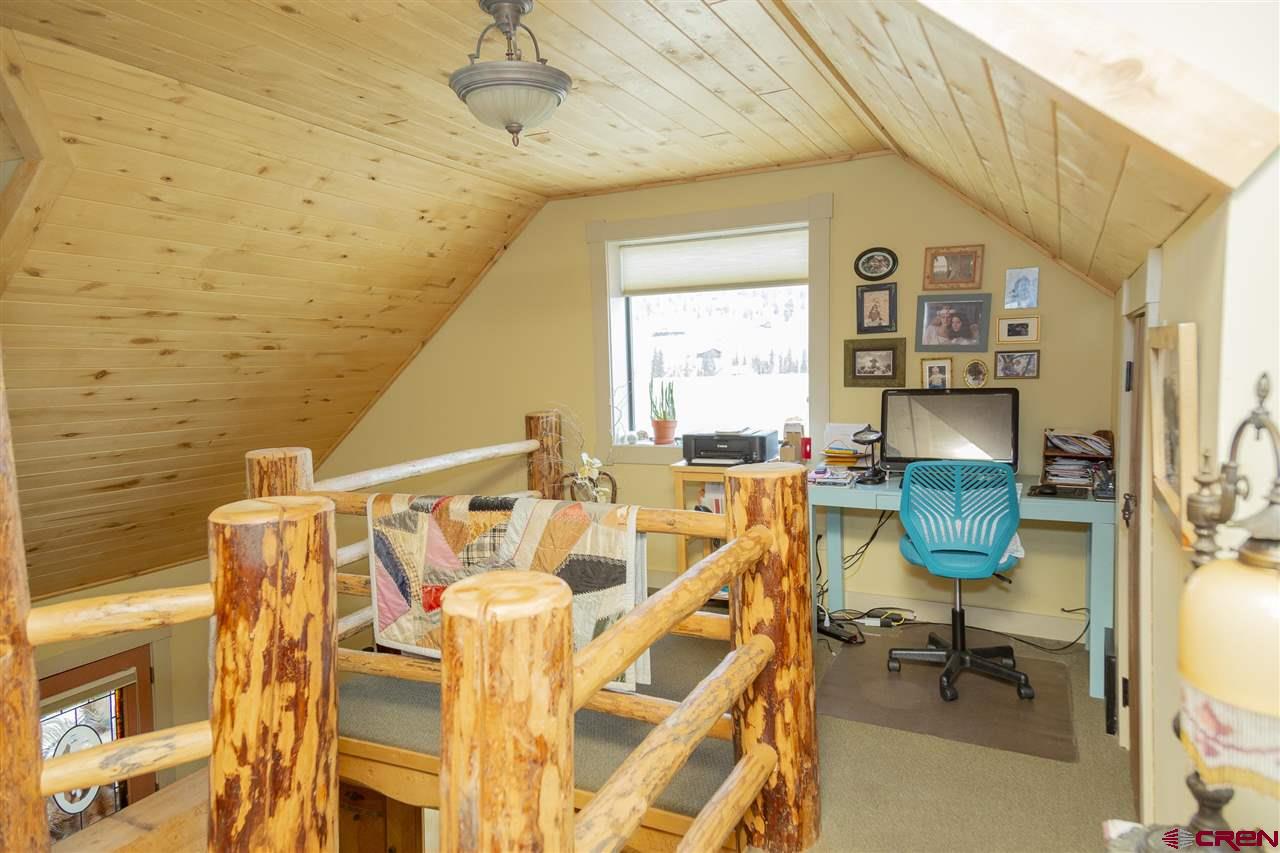 148 Rio Grande Drive Creede, CO 81130 - Photo 16 of 27 a view of a patio with table and chairs with wooden floor
