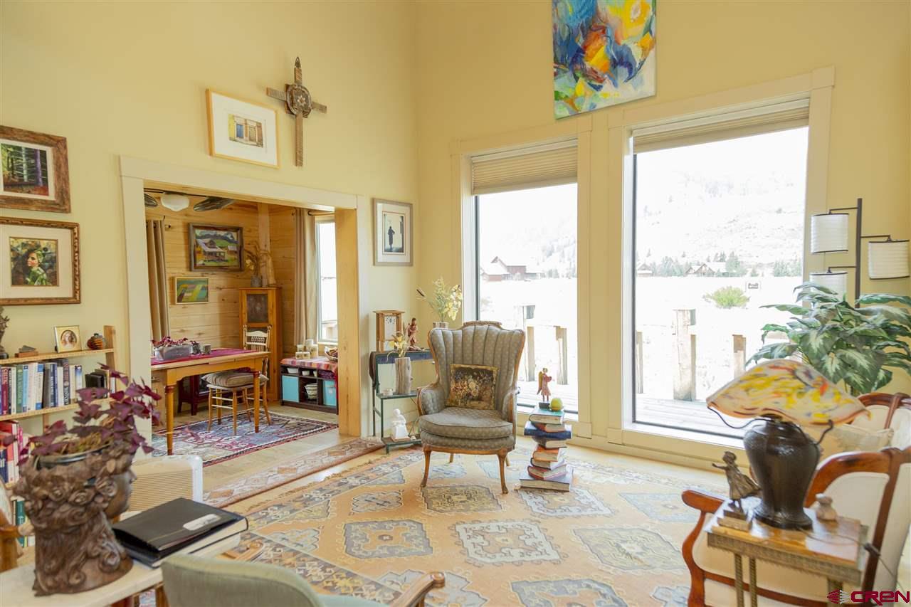 148 Rio Grande Drive Creede, CO 81130 - Photo 6 of 27 a living room with furniture and floor to ceiling windows