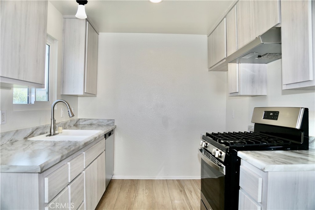 16702 Blanton Lane Huntington Beach, CA 92649 - Photo 3 of 19 a kitchen with stainless steel appliances granite countertop a sink stove and cabinets