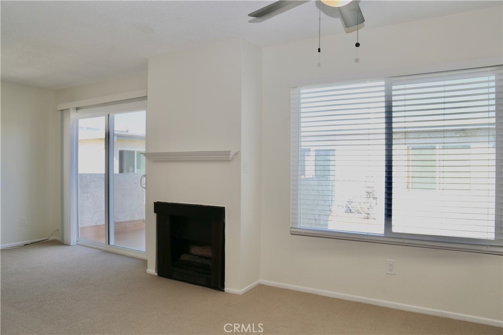 16702 Blanton Lane Huntington Beach, CA 92649 - Photo 6 of 19 a view of an empty room with a fireplace and a window