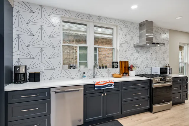a kitchen with stainless steel appliances a sink and cabinets
