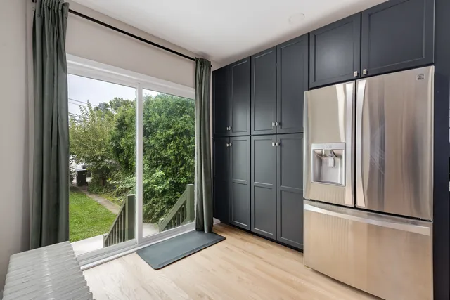 a kitchen with stainless steel appliances a refrigerator and a gate