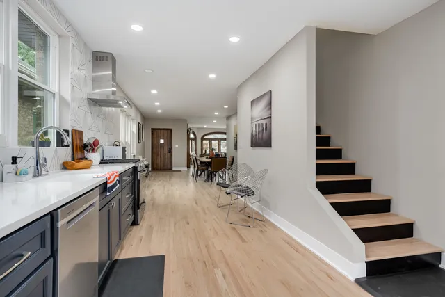 a view of a kitchen with furniture and wooden floor