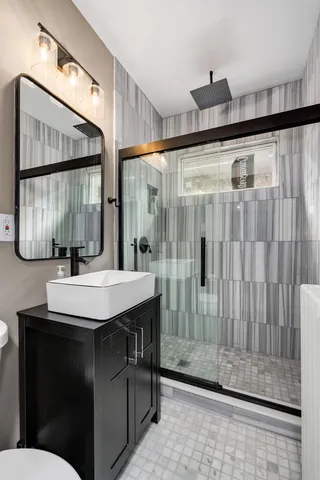 a bathroom with a sink a mirror and a shower