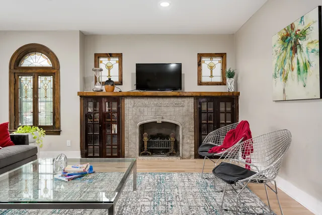a living room with furniture fireplace and flat screen tv