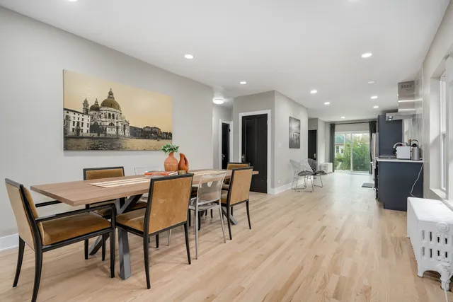 a dining room with furniture and a wooden floor