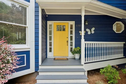 a view of front door of house with stairs