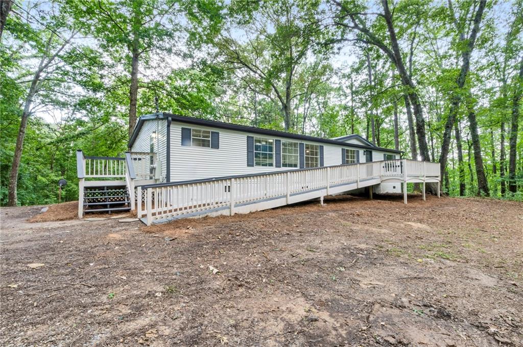 a view of backyard with deck and trees