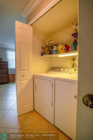 a view of storage and utility room with washer and dryer