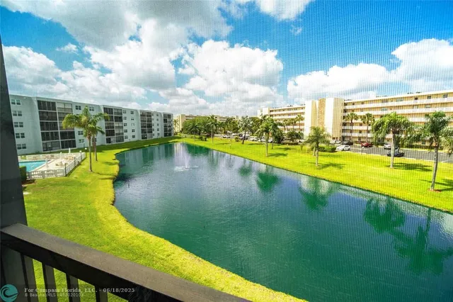 a view of a swimming pool with an outdoor seating and a yard
