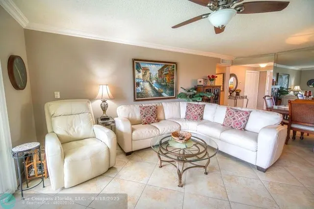 a living room with furniture and a ceiling fan