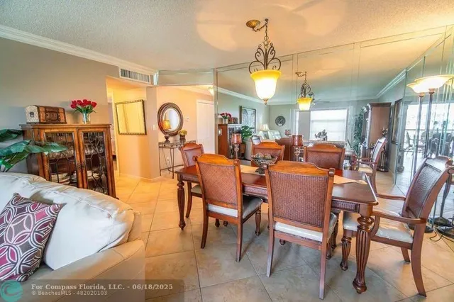 a dining hall with furniture a large window and a fireplace