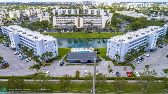an aerial view of multiple houses with yard
