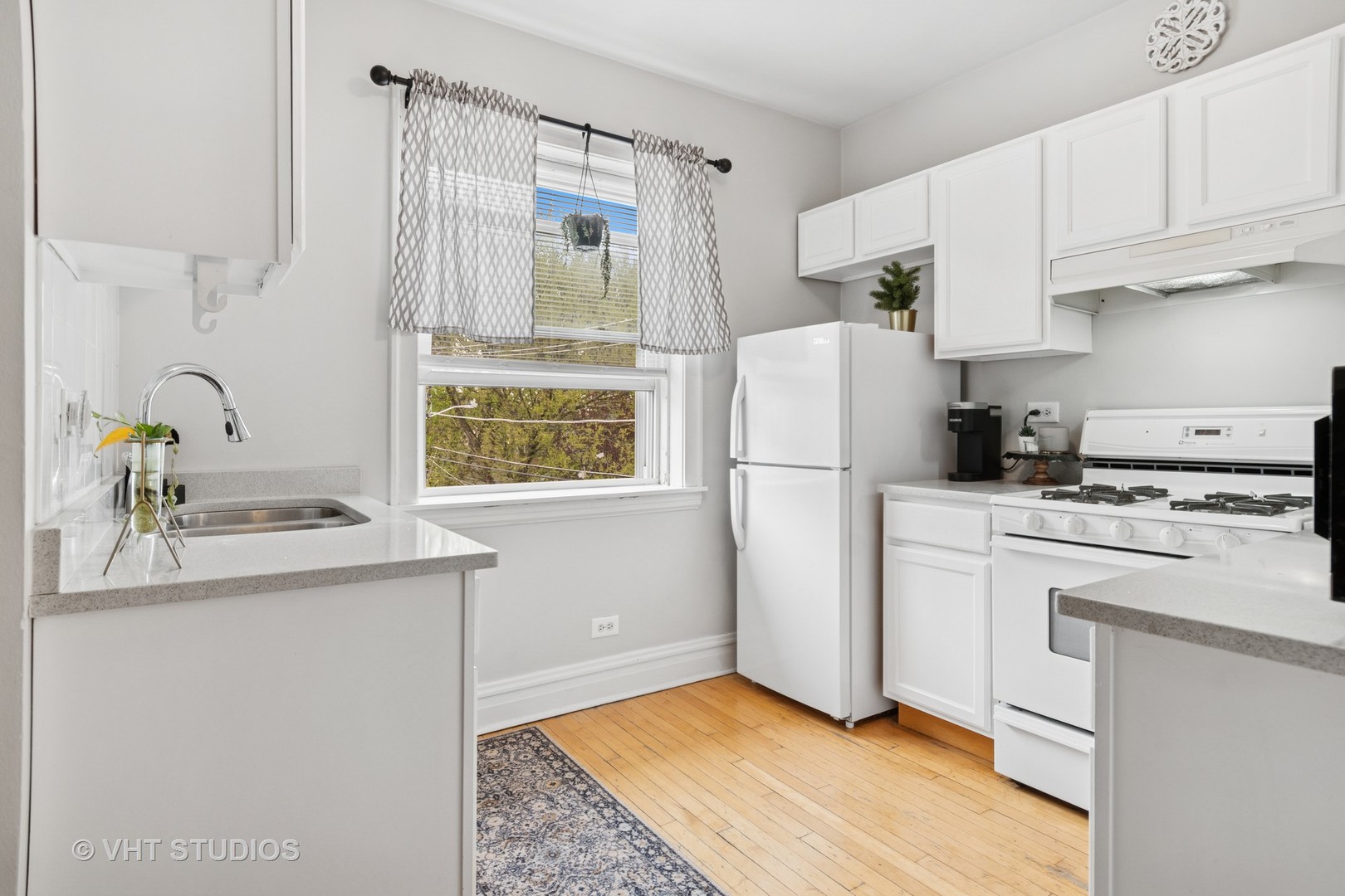 7 Fillmore Street, Unit 2 Oak Park, IL 60304 - Photo 15 of 27 a kitchen with a refrigerator sink stove and white cabinets