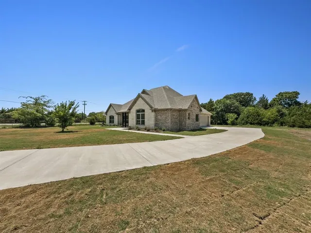 a view of big yard with large trees