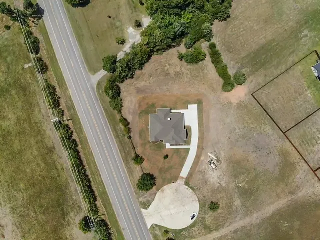 an aerial view of a house with wooden floor