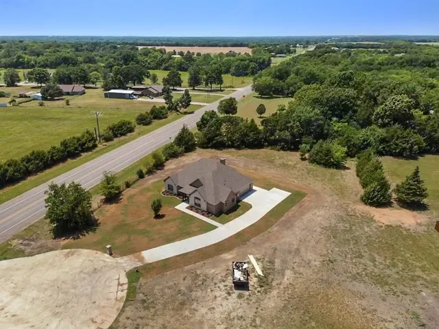 a view of a back yard of a house with a yard