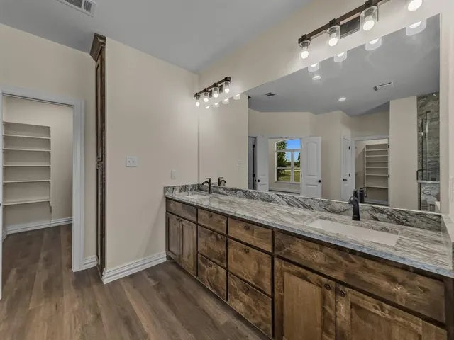 a bathroom with a double vanity sink and a mirror