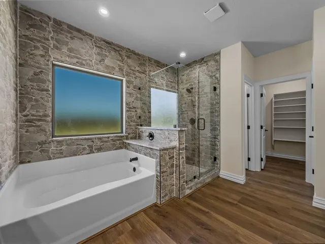 a spacious bathroom with a bathtub and a shower